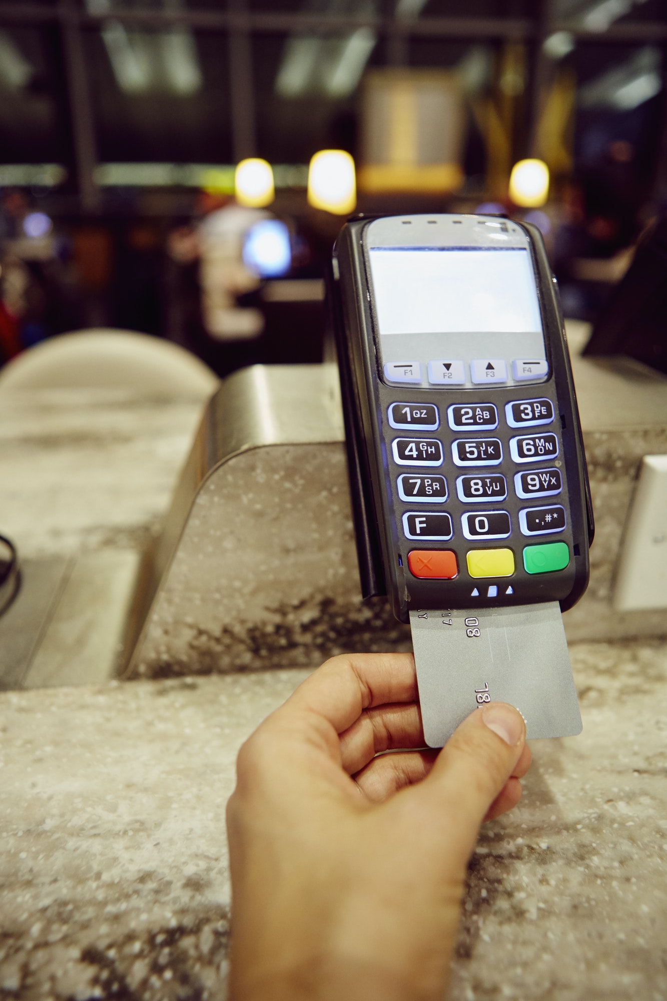 womans-hand-using-credit-card-machine-for-restaurant-payment